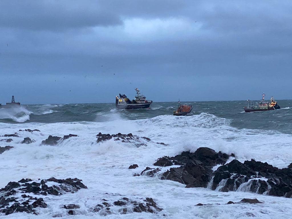 The lifeboat attached a tow to the stricken vessel (left) and towed it to safety (RNLI Peterhead/PA)