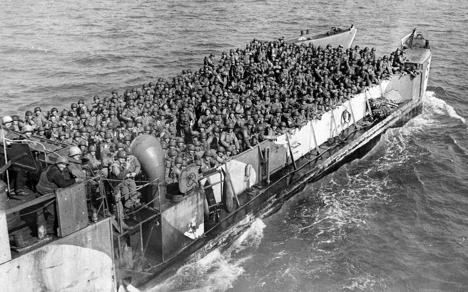 FILE - American troops pack a landing craft underway to a beachhead at the northern coast of France, during the Allied invasion of Normandy, June 19, 1944. The D-Day invasion that helped change the course of World War II was unprecedented in scale and audacity. Veterans and world dignitaries are commemorating the 79th anniversary of the operation. (AP Photo, File)