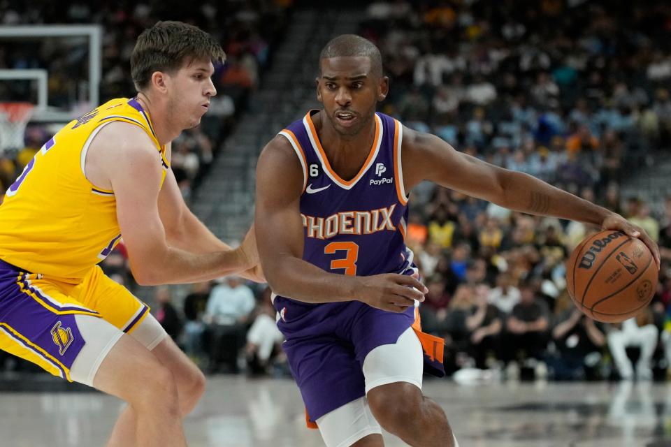 Phoenix Suns guard Chris Paul (3) drives around Los Angeles Lakers guard Austin Reaves (15) during the first half of a preseason NBA basketball game Wednesday, Oct. 5, 2022, in Las Vegas.