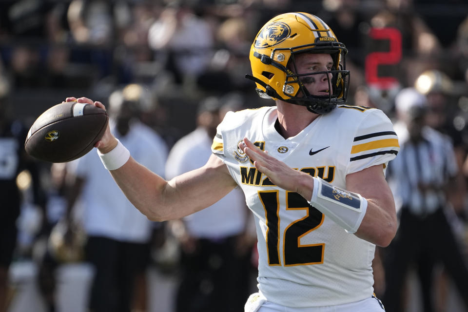 Missouri quarterback Brady Cook (12) looks to throw a pass against Vanderbilt in the first half of an NCAA college football game Saturday, Sept. 30, 2023, in Nashville, Tenn. (AP Photo/George Walker IV)