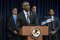 United States Attorney Markenzy Lapointe speaks to the media about a network of nursing school operators, centered in South Florida, who allowed students to buy diplomas without the proper training as representatives from FBI Miami and Department of Health and Human Services Office of Inspector General (HHS-OIG), Miami Regional Office stand behind him during a press conference at the U.S. Attorney's Office for the Southern District of Florida in Downtown Miami on Wednesday, Jan. 25, 2023. (D.A. Varela/Miami Herald via AP)