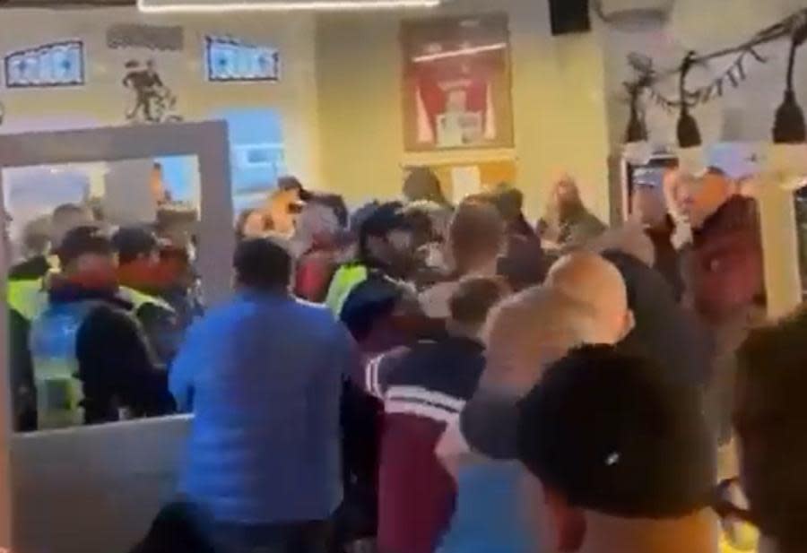 Swindon Advertiser: An image from a video appearing to show fans fighting in a Swindon pub