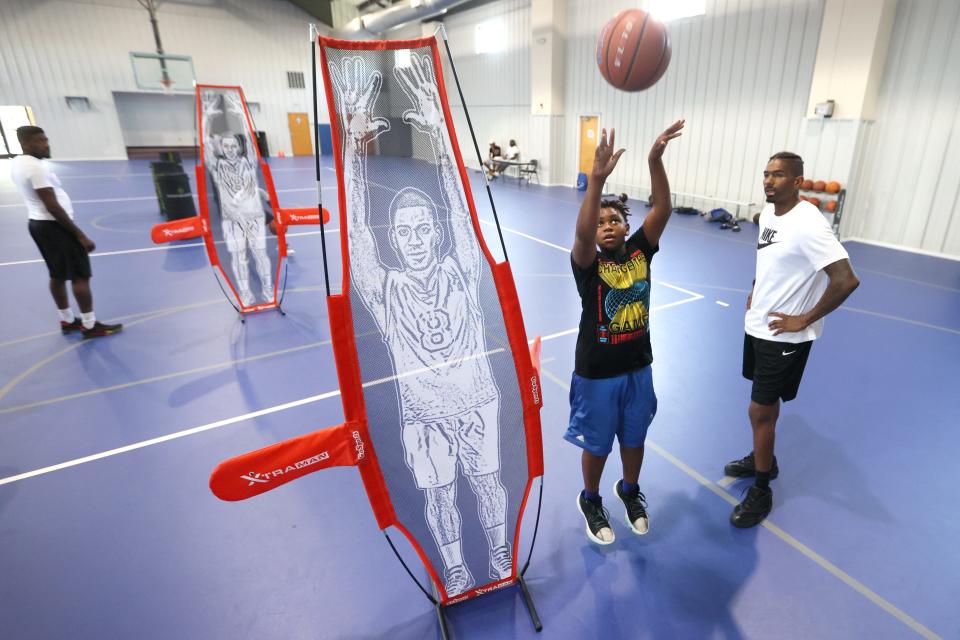 Ajani Brandon, 12, works on his basketball skills next to trainer Jeremy Hunt at former Tigers star Willie Kemp's new venture, Beyond The Game 901, designed to help kids excel at sports while also mentoring and stressing to them that there’s more to life than athletics. Sessions for the basketball camp are held at Early Grove Baptist Church gym on Thursday, June 16, 2022. 