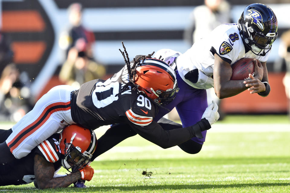 FILE - Cleveland Browns linebacker Jadeveon Clowney (90) tackles Baltimore Ravens quarterback Lamar Jackson (8) for no gain during the first half of an NFL football game, Sunday, Dec. 12, 2021, in Cleveland. Clowney has agreed to a contract with the Ravens, according to a person with knowledge of the agreement. The person spoke on condition of anonymity Friday, Aug. 18, 2023, because the deal hadn't been announced. (AP Photo/David Richard, FIle)