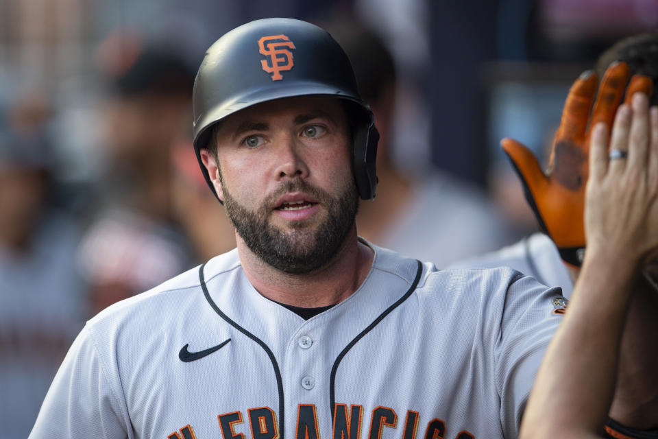 San Francisco Giants Darin Ruf high fives teammates in the dugout after a solo home run in the fourth inning of a baseball game against the Atlanta Braves Wednesday, June 22, 2022, in Atlanta. (AP Photo/Hakim Wright Sr.)