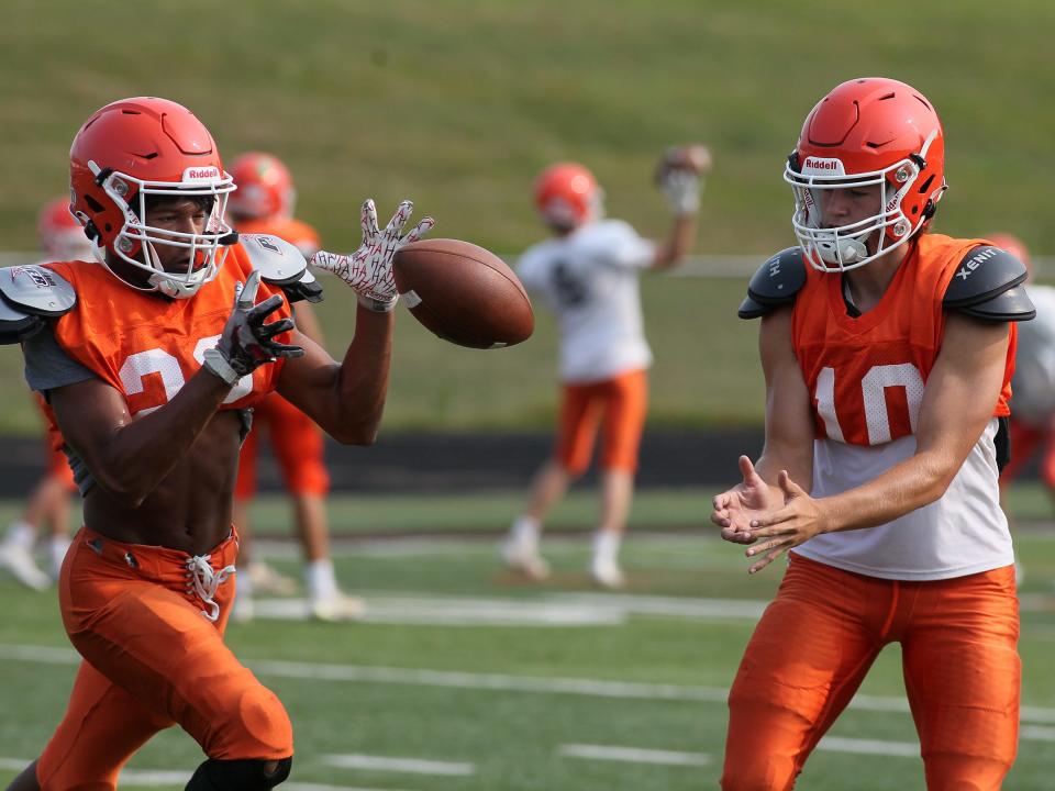 Heath's Brayden Bayles pitches to Daylen McIntyre during practice at Swank Field on Tuesday, Aug. 1, 2023.