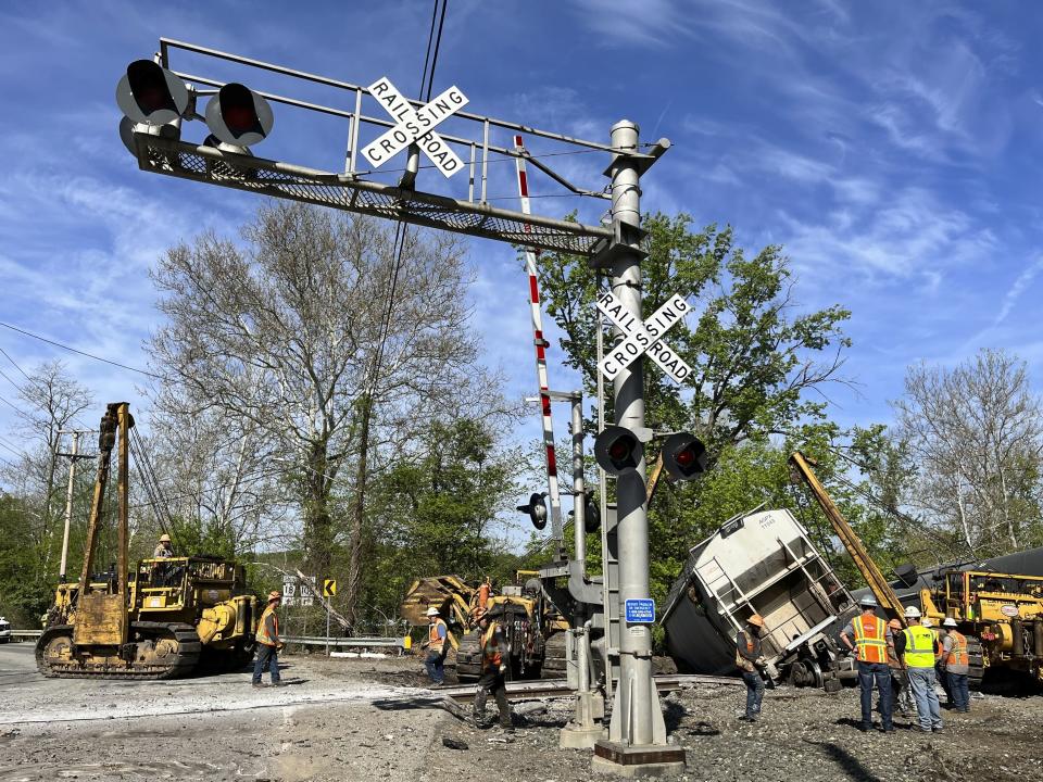 Emergency personnel respond at the scene of a train derailment outside New Castle, Pa., on Thursday, May 11, 2023. Officials say nine railcars from a Norfolk Southern freight train derailed in Pennsylvania, with no hazardous chemicals on board and no reported injuries (Lucy Schaly/Pittsburgh Post-Gazette via AP)