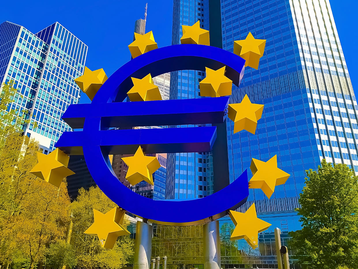 blockchain  Frankfurt, Germany - April 24, 2022: Euro sign sculpture in a park among modern office towers in Frankfurt and Ukrainian flag- Ukraine and Europe concept