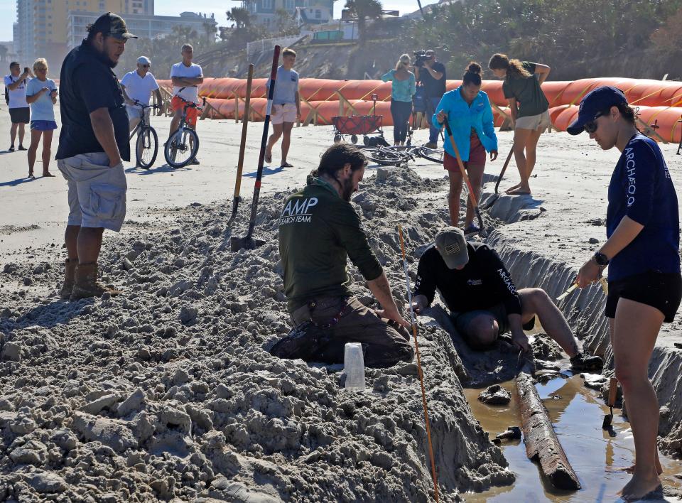 Archaeology crew members from St. Augustine Lighthouse & Maritime Museum's research program sift through debris that was exposed during Tropical Storms Ian and Nicole, Tuesday, Dec. 6, 2022. Researchers believe the object is an old merchant ship, dating back to the 1800s.