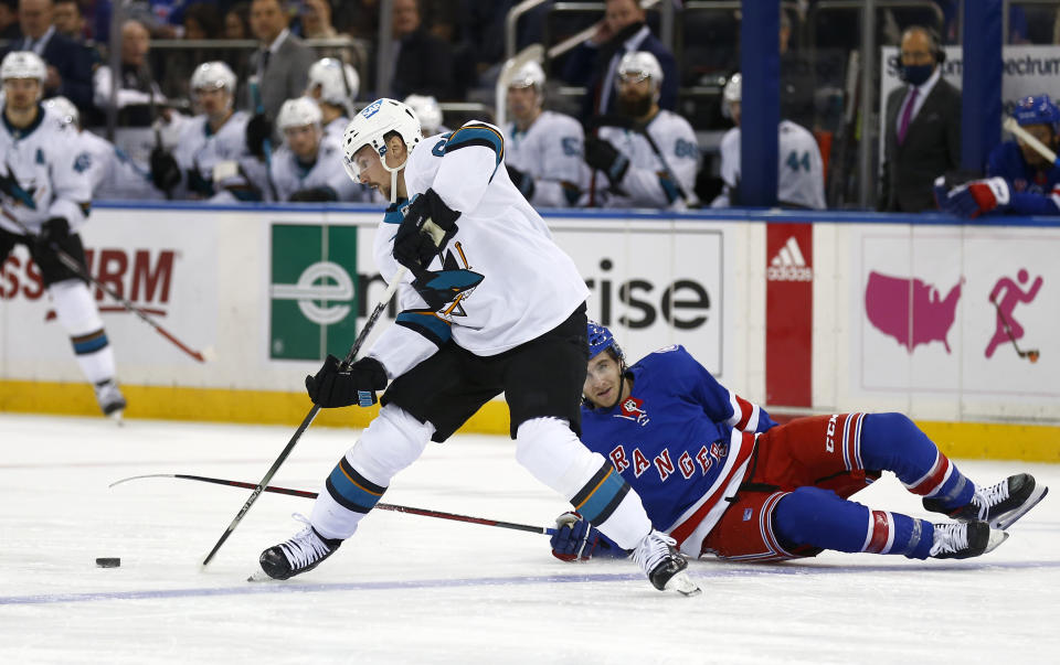 San Jose Sharks' Erik Karlsson (65) avoids New York Rangers' Kevin Rooney (17) during the second period of an NHL hockey game Friday, Dec. 3, 2021, in New York. (AP Photo/John Munson)