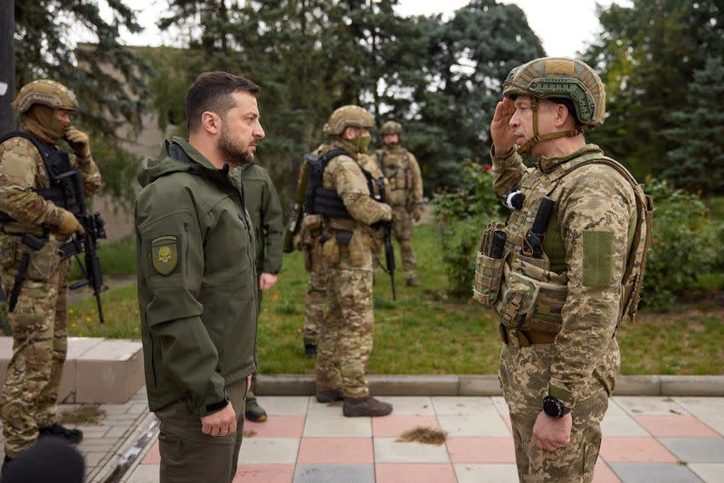 Ukraine's President Zelenskiy listens to Commander of the Ground Forces colonel general Syrskyi in the recently liberated town of Izium