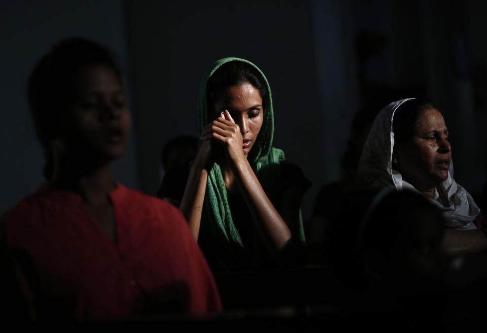 Catholic devotees pray during a Good Friday mass inside a church in New Delhi