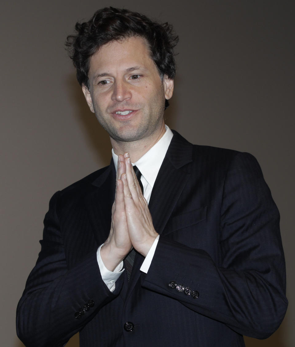 FILE - In this Oct. 30, 2011 file photo, film director Bennett Miller reacts during the closing ceremony of the 24th Tokyo International Film Festival in Tokyo. The director of the award-winning baseball movie "Moneyball" is now looking at wrestling. Miller, in the upcoming film "Foxcatcher," examines the dedication of athletes with almost no promise of tangible award. The project comes with wrestling fighting for its Olympic existence. (AP Photo/Shizuo Kambayashi, File)