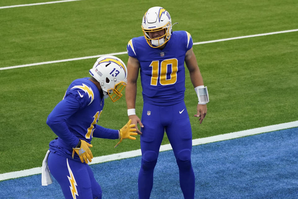 Los Angeles Chargers wide receiver Keenan Allen (13) celebrates after catching a touchdown pass with quarterback Justin Herbert.