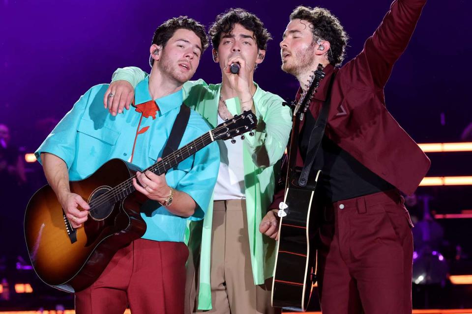 <p>Kevin Mazur/Getty</p> Nick Jonas, Joe Jonas, an Kevin Jonas perform onstage during Jonas Brothers 