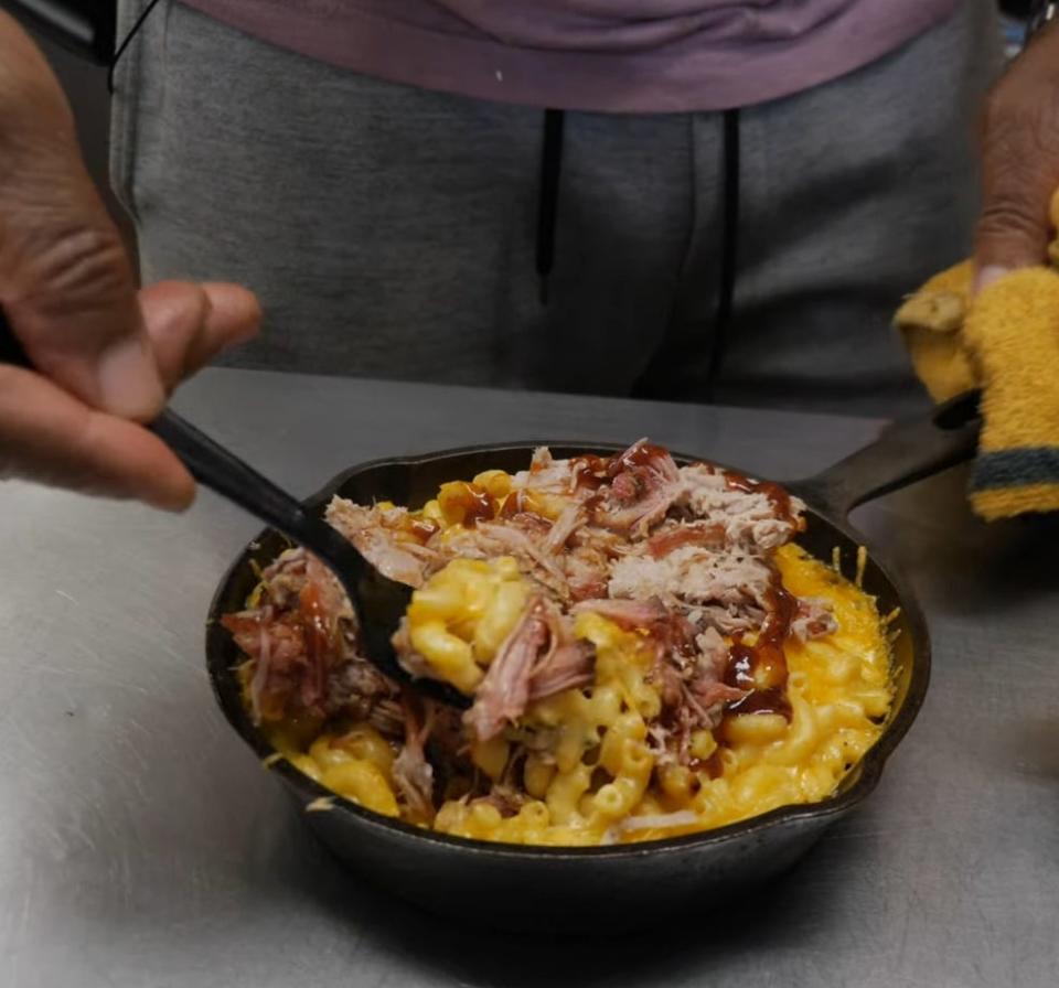 Barbecue pulled pork with mac 'n' cheese in a small cast-iron pan