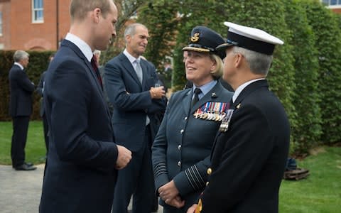 Prince William, Duke of Cambridge speaks to Group Captain Teresa Griffiths (C), the Commanding Officer at DMRC Headley Court, and Surgeon Commodore Andrew Hughes (R). - Credit: Oli Scarff/Getty Images