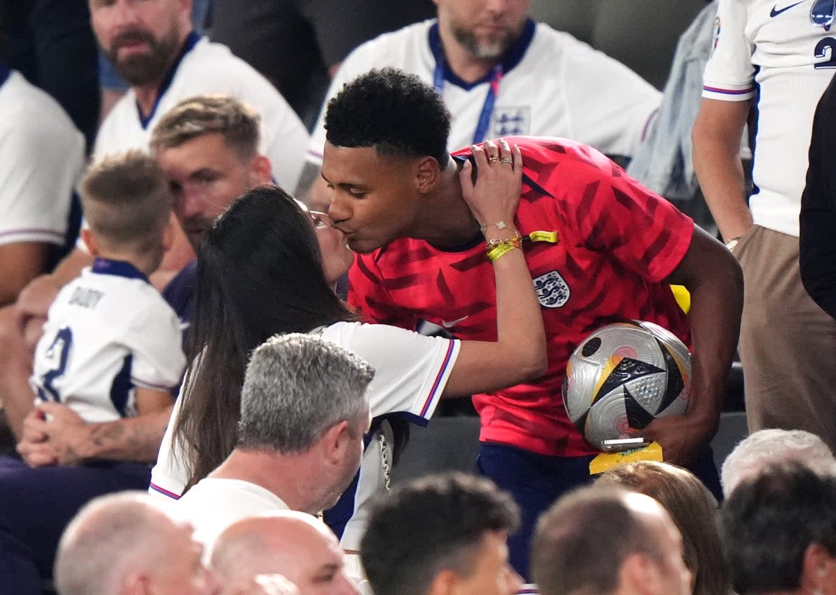 Ollie Watkins kisses girlfriend Ellie Alderson (PA)