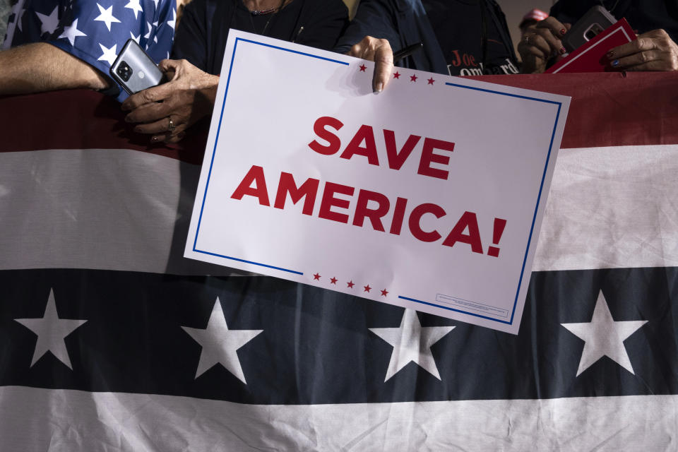 FILE - A Republican supporter holds a "Save America" sign at a rally for former President Donald Trump at the Minden Tahoe Airport in Minden, Nev., Saturday, Oct. 8, 2022. A new poll finds that only about 1 in 10 U.S. adults give high ratings to the way democracy is working in the United States or how well it represents the interests of most Americans.(AP Photo/José Luis Villegas, Pool, File)