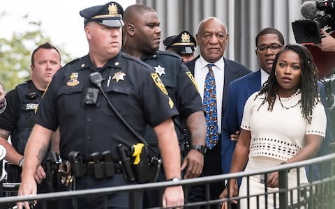 Bill Cosby surrounded by police outside the court in Norristown, Pennsylvania - Credit: Gilbert Carrasquillo /Getty