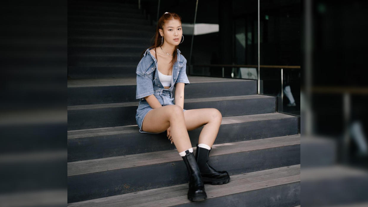 Singaporean actress Chen Yixin sitting on steps