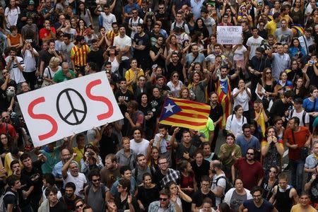 People hold up placards during a demonstration two days after the banned independence referendum in Barcelona, Spain October 3, 2017. REUTERS/Susana Vera