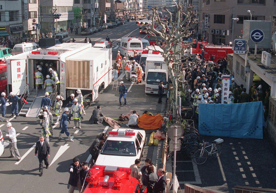 FILE - In this March 20, 1995, file photo, subway passengers affected by sarin nerve gas are treated near Tsukiji subway station, right, in Tokyo. The last six members of Japanese doomsday cult Aum Shinrikyo who remained on death row were executed Thursday, July 26, 2018, for a series of crimes in the 1990s including the sarin gas attack on Tokyo subways that killed 13 people. (Kyodo News via AP, File)/Kyodo News via AP)