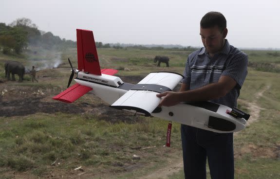 Remo Peduzzi, Managing Director at Research Drones LLC Switzerland, prepares to launch an unmanned drone at the Kaziranga National Park at Kaziranga in Assam state, India, on Monday, April 8, 2013.