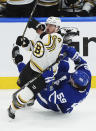 Boston Bruins' Brad Marchand (63) checks Toronto Maple Leafs' Tyler Bertuzzi (59) during first-period action in Game 4 of an NHL hockey Stanley Cup first-round playoff series in Toronto, Saturday, April 27, 2024. (Nathan Denette/The Canadian Press via AP)