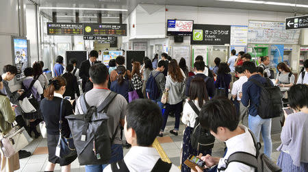 Passengers are seen at Nijyo station in Kyoto, western Japan after train services were suspended because of an earthquake, in this photo taken by Kyodo June 18, 2018. Mandatory credit Kyodo/via REUTERS