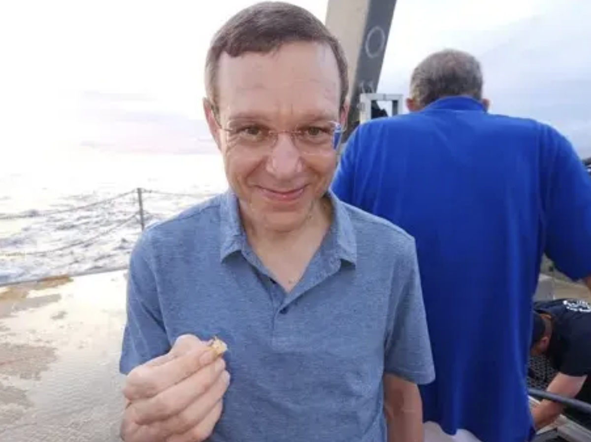 Harvard professor Avi Loeb with a piece of magnetic debris dredged from the Pacific Ocean (Avi Loeb / Medium)