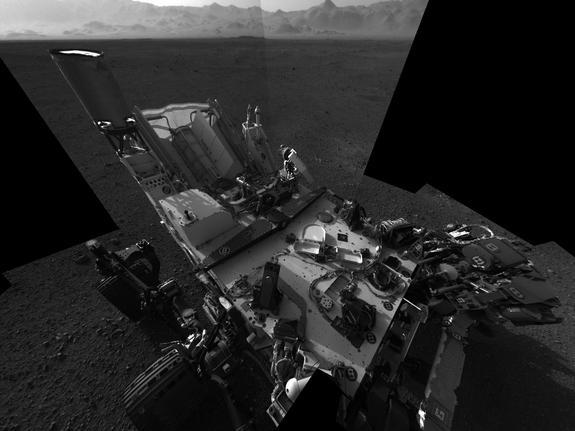 This high-res mosaic of 20 images is the first clear self-portrait of NASA's Mars rover Curiosity on the Red Planet. The rear of the rover is at top, with two right-side wheels on the left. The rim of Gale Crater forms the lighter-color strip o