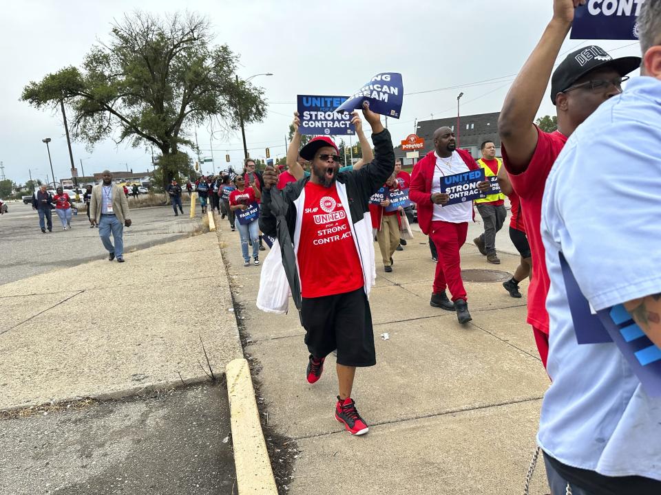 FILE - United Auto Workers members march while holding signs at a union rally held near a Stellantis factory Wednesday, Aug. 23, 2023, in Detroit. The demands that a more combative United Auto Workers union has made of General Motors, Stellantis and Ford — demands that even the UAW's president has called “audacious” — are edging it closer to a strike when its current contract ends Sept. 14. (AP Photo/Mike Householder, File)