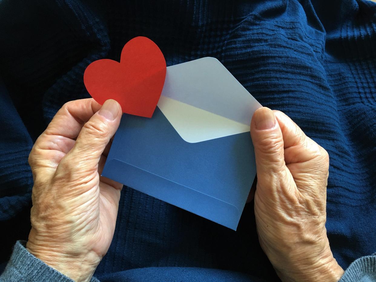 Valentine's card in hand - stock photo.