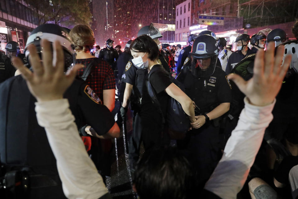 Police arrest protesters as they march through the streets of Manhattan, New York, Wednesday, June 3, 2020. New York City Mayor Bill de Blasio says that the city has taken a "step forward" in restoring order with the help of an early curfew. Tuesday night brought more big protests over the death of George Floyd and sporadic reports of vandalism, but much less of the widespread plundering of stores amid a huge police presence. (AP Photo/Seth Wenig)