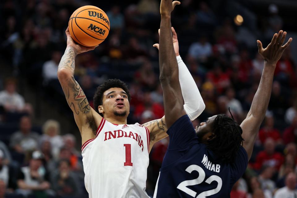 Mar 14, 2024; Minneapolis, MN, USA; Indiana Hoosiers center Kel'el Ware (1) shoots as Penn State Nittany Lions forward Qudus Wahab (22) defends during the first half at Target Center.