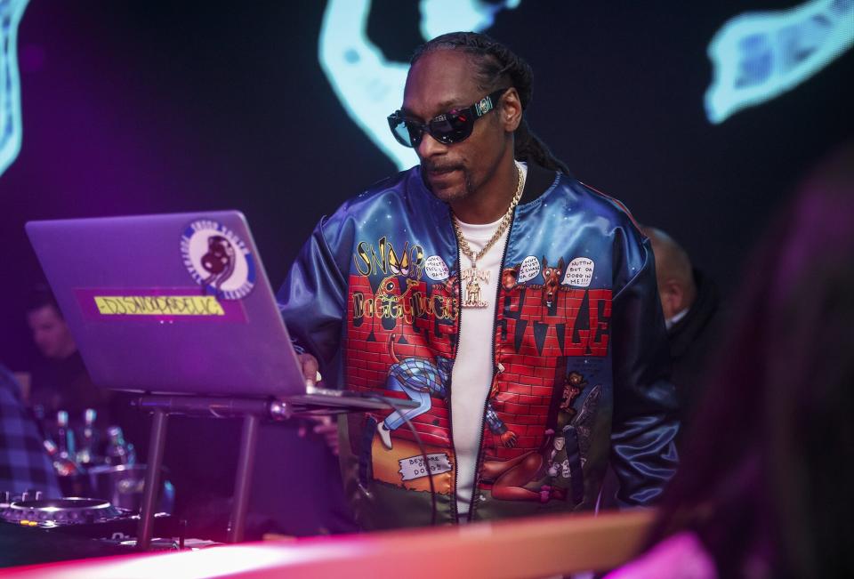 Snoop Dogg hits the turntables at The Grand in Boston on Monday night after attending the Boston Celtics basketball game against the Los Angeles Lakers.