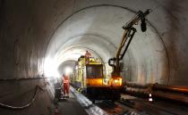 A worker stands on the special train 'Helvetia' in the NEAT Gotthard Base tunnel near Erstfeld May 7, 2012. The train, which is 481 metres (1578 ft) long and weighs 787 tons, is constructed to produce concrete for the installation of the railway tracks in the tunnel. Crossing the Alps, the world's longest train tunnel should become operational at the end of 2016. The project consists of two parallel single track tunnels, each of a length of 57 km (35 miles ) REUTERS/Arnd Wiegmann (