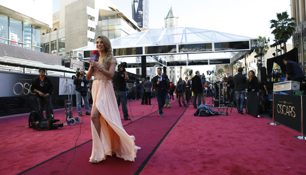 ��Antonella Michelena, a television reporter from Mexico, is silhouetted as she reports from the red carpet outside the Dolby Theatre in the Hollywood section of Los Angeles. (Credit: PA)