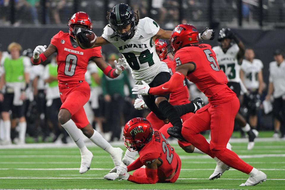 Hawaii wide receiver Nick Mardner (84) is tackled by UNLV during the second half of an NCAA college football game Saturday, Nov. 13, 2021, in Las Vegas. (AP Photo/David Becker)