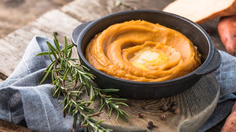 mashed sweet potatoes with rosemary in a bowl