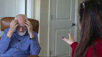 In this frame grab made from video, Democrat Jim Carpenter, left, and Republican Natalie Abbas watch the inauguration of President Joe Biden in Carpenter's apartment in Frederick, Md., Wednesday, Jan. 20, 2021. The two are local ambassadors for a program designed to bridge the nation's extraordinary political divide. (AP Photo/Allen G. Breed)