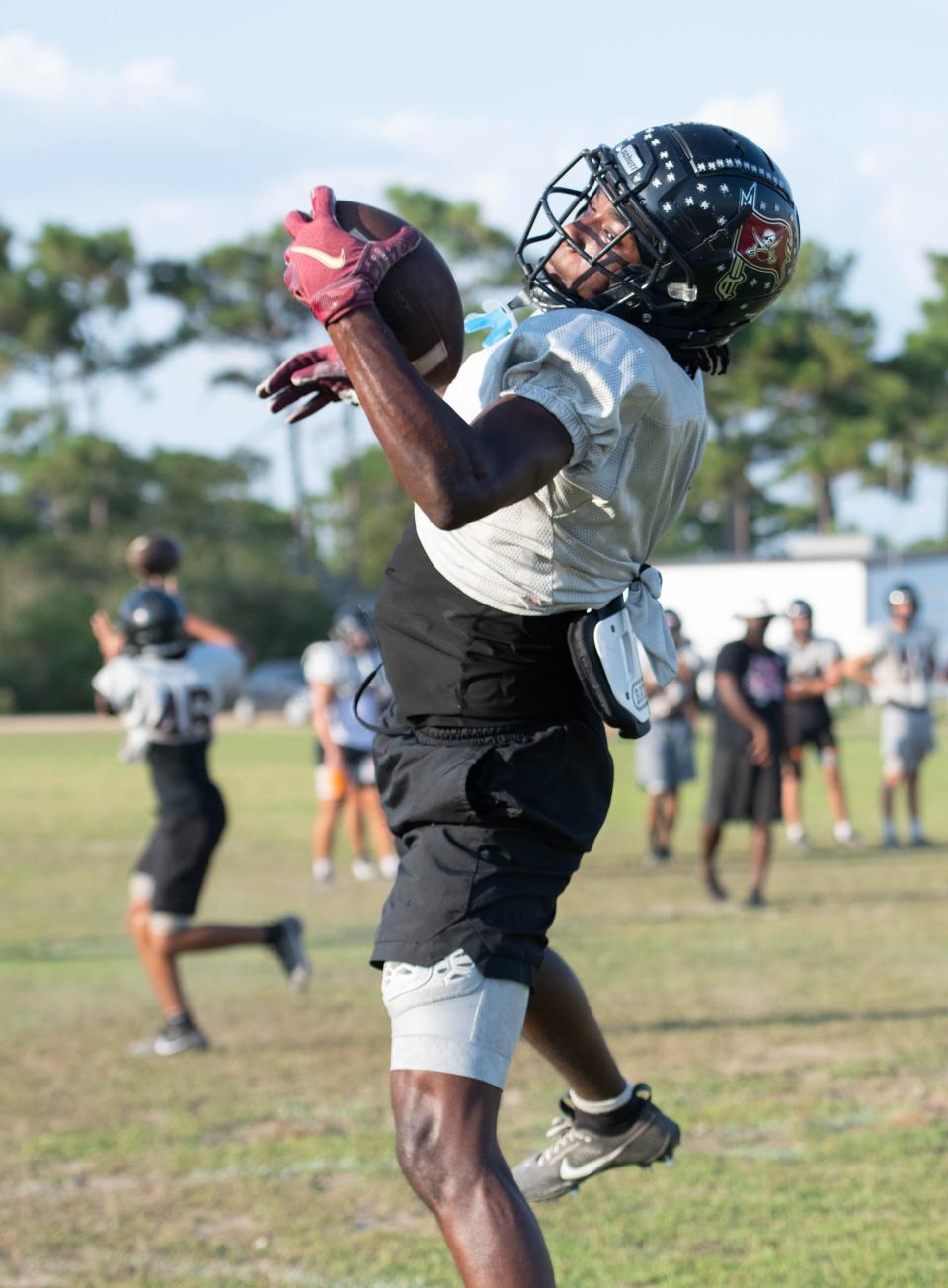 Terence Marshall (1) receives a pass during football practice at Navarre High School on Wednesday, Aug. 2, 2023.