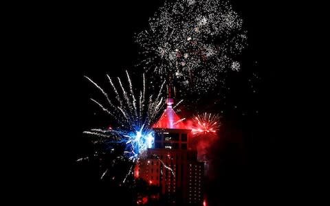 Fireworks explode over the UAP Old Mutual Tower during New Year celebrations in Nairobi - Credit: Reuters