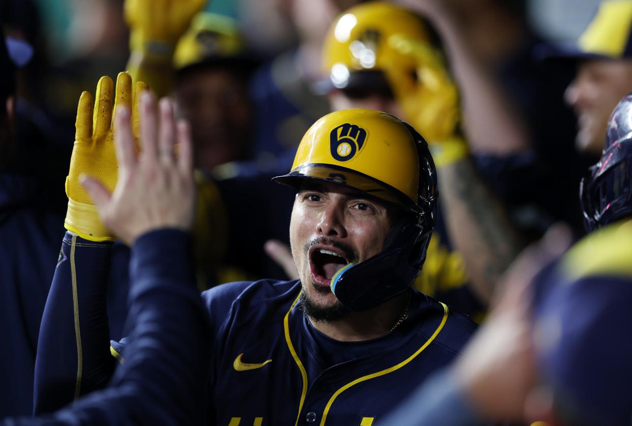 Willy Adames is congratulated by teammates in the dugout after hitting a 3-run go-ahead home run during the 9th inning.