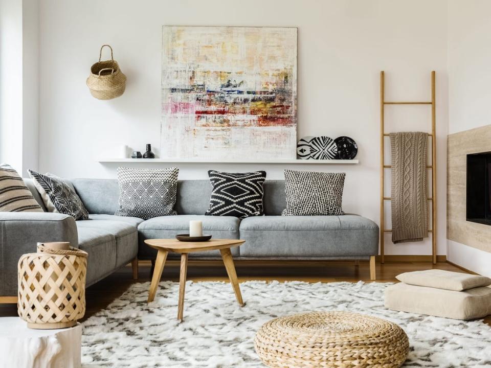 Neutral-toned living room with funky pillows and large canvas.