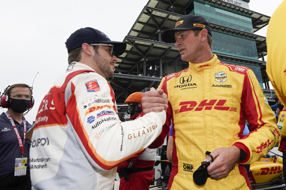 Marco Andretti, left, talks with Ryan Hunter-Reay during qualifications for the Indianapolis 500 auto race at Indianapolis Motor Speedway, Saturday, May 22, 2021, in Indianapolis. (AP Photo/Darron Cummings)