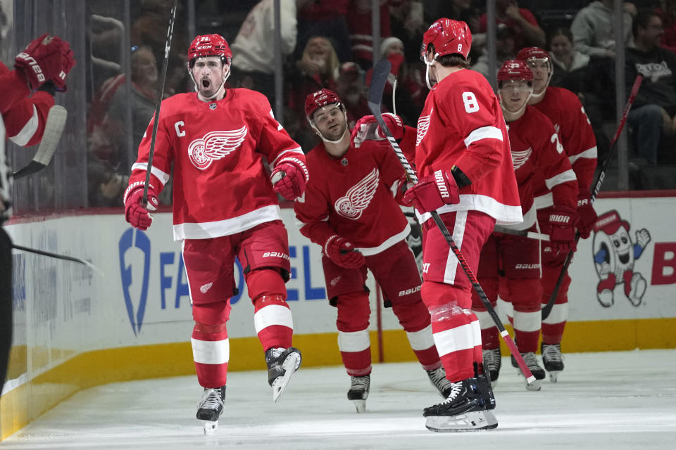 Detroit Red Wings center Dylan Larkin, left, celebrates his goal against the Calgary Flames in the second period of an NHL hockey game Sunday, Oct. 22, 2023, in Detroit. (AP Photo/Paul Sancya)