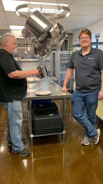 Chefs Terry Hope and Josh Brantley working in the kitchen at Woody’s, perfecting one of the appetizers – Smokestack Nachos.