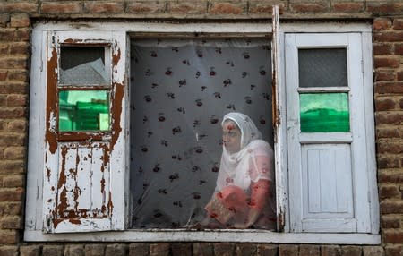 The Wider Image: Barricades and books in restive Kashmir neighbourhood